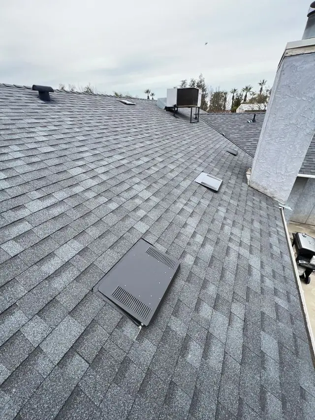 Gray shingle roof with ventilation system installed